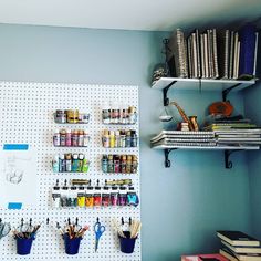 there are many craft supplies on the pegboard in this room, including pens and scissors