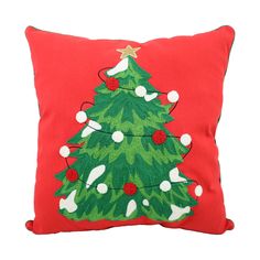 a red pillow with a christmas tree on it