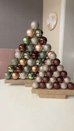 a christmas tree made out of ornaments sitting on top of a table