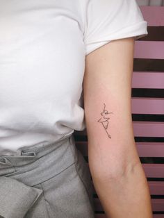 a woman with a small tattoo on her arm