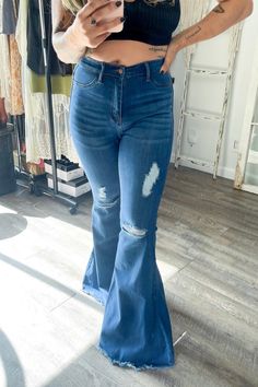 A pair of exaggerated, high-rise flare jeans featuring a front whiskered wash, open distressed knee detail, classic 5-pocket construction, frayed raw hem, and a zip-fly closure.-Rise: 11" Inseam: 33"-True to size Made In: Imported Fabric Contents: 60% Cotton, 32% Modal, 7% T400, 1% Lycra Distressed Cutoff Flare Jeans For Fall, Mid-rise Distressed Denim Blue Flare Jeans, Mid-rise Ripped Dark Wash Flare Jeans, Dark Wash Mid-rise Ripped Flare Jeans, Mid-rise Distressed Medium Wash Flare Jeans, Dark Wash Ripped Mid-rise Flare Jeans, Ripped Mid-rise Flare Jeans For Fall, Mid-rise Ripped Flare Jeans For Fall, Mid-rise Distressed Flare Jeans For Fall