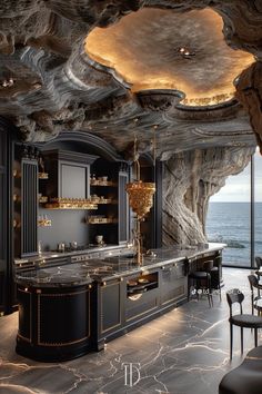 an elegant kitchen with marble counter tops and black cabinets, along with large windows that look out onto the ocean