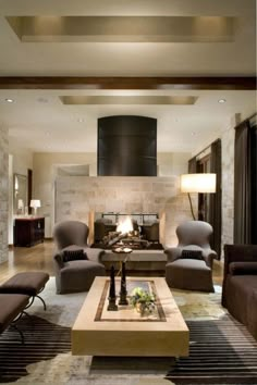 a living room filled with furniture and a fire place in the middle of a room