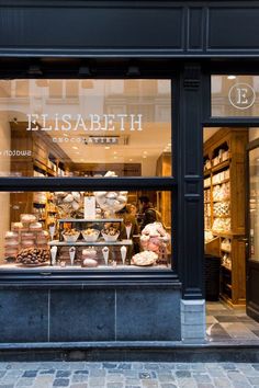 a store front with an assortment of pastries in the window