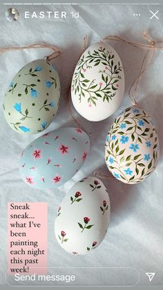 four painted eggs are sitting next to each other