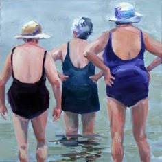 three women in swimsuits are standing in the water at the beach looking out to sea