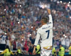 a soccer player waves to the crowd in front of him