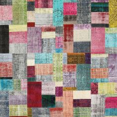 multicolored patchwork rug with squares and rectangles in various colors, on top of each other