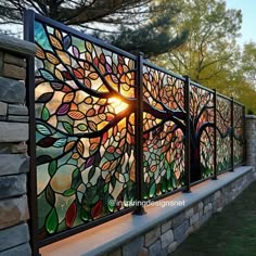 a decorative glass window on the side of a stone wall