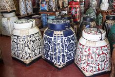 many different vases are on display in a store