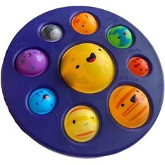 an image of a toy that is in the shape of a circle with different faces