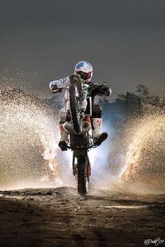 a man riding on the back of a dirt bike