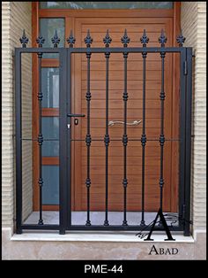 an image of a door that is closed and has metal bars on the front gate