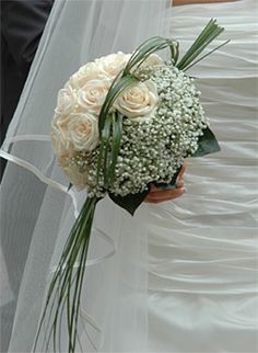 the bride's bouquet was made up of white roses and baby's breath