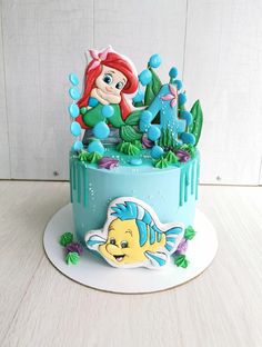 the little mermaid cake is decorated with fondant