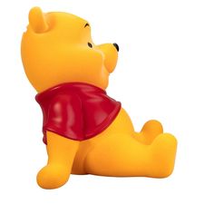 a winnie the pooh toy laying on its side