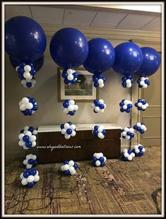 blue and white balloons are floating in the air