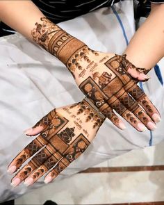 two hands with hendi designs on them