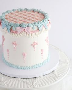 a white cake with pink and blue frosting