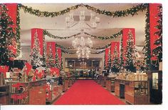 a red carpeted room with christmas trees and presents