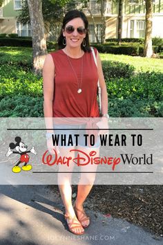 a woman standing in front of a building with the words what to wear to walt world