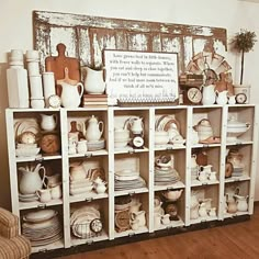 a shelf filled with lots of white dishes