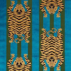 a blue and green rug with tiger designs on the front, two smaller ones in the back