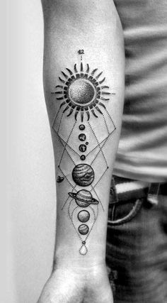 a man with a tattoo on his arm that has the sun and planets in it