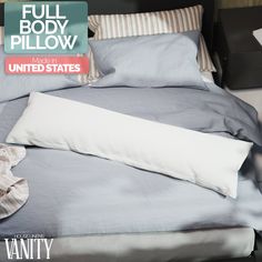 a bed with two pillows and a pillow case on top of it that says full body pillow