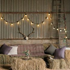 a living room with hay bales and lights