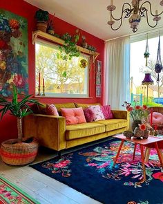 a living room filled with lots of furniture and colorful rugs on the floor next to a window