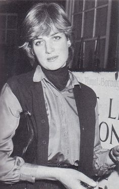 an old photo of a woman holding something in her hand