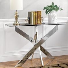 a glass table topped with books and a lamp