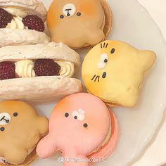 a white plate topped with pastries covered in icing