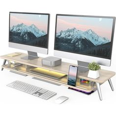 two computer monitors sitting on top of a wooden desk next to a keyboard and mouse