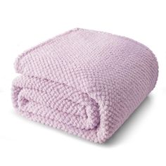 a purple blanket is folded up on a white surface