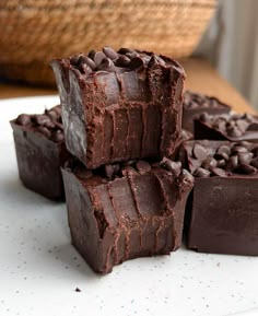 several pieces of chocolate sitting on top of a white plate