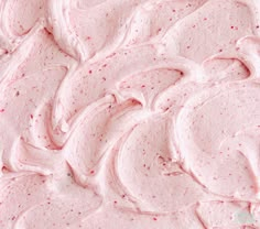 a close up view of pink frosted cake