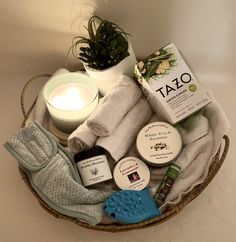 a basket filled with towels, candles and other items