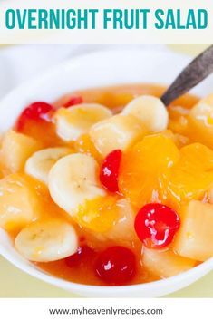 a white bowl filled with fruit salad on top of a yellow tablecloth and text overlay reads overnight fruit salad