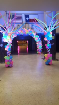 an archway decorated with balloons and streamers