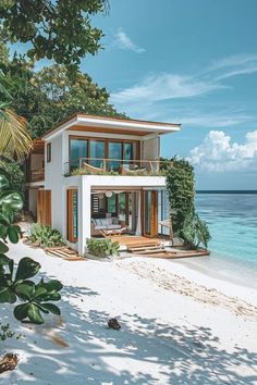 a house on the beach is surrounded by greenery