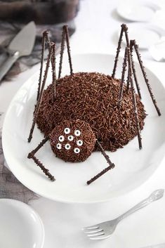 a spider cake on a white plate with forks