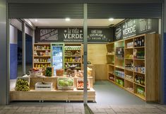 a store front with shelves full of food and drinks in it's display area