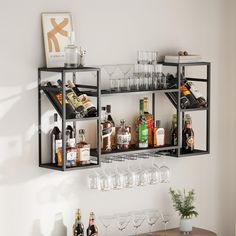 a shelf filled with bottles and glasses next to a wall mounted wine glass rack on the wall