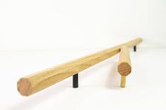 a pair of wooden pegs sitting next to each other on top of a white surface