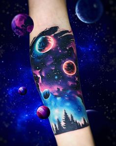 an arm with planets in the sky and trees on it, as well as stars