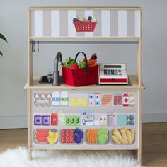 a toy kitchen with fruits and vegetables on it