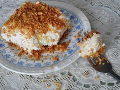 a piece of cake sitting on top of a white and blue plate next to a fork