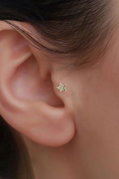 a woman's ear with a small star on it